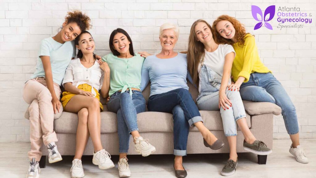 A group of ladies from various age groups sitting on a couch.