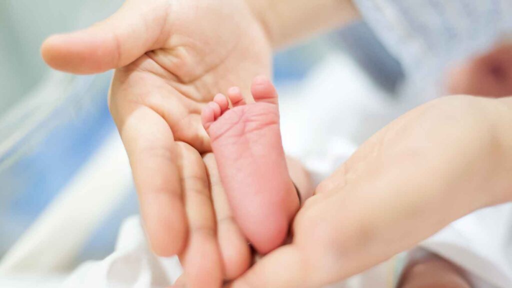 A close-up of a newborn baby's foot